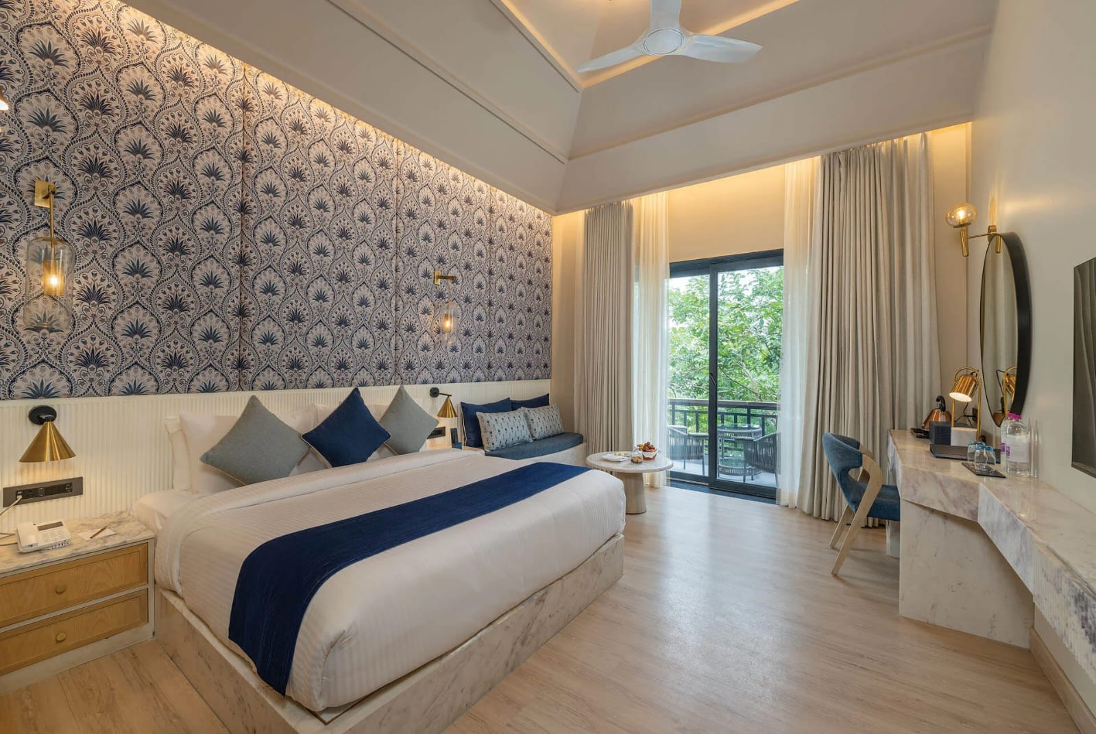 Premier king room with indigo wallpaper, marble desk and forest-view balcony